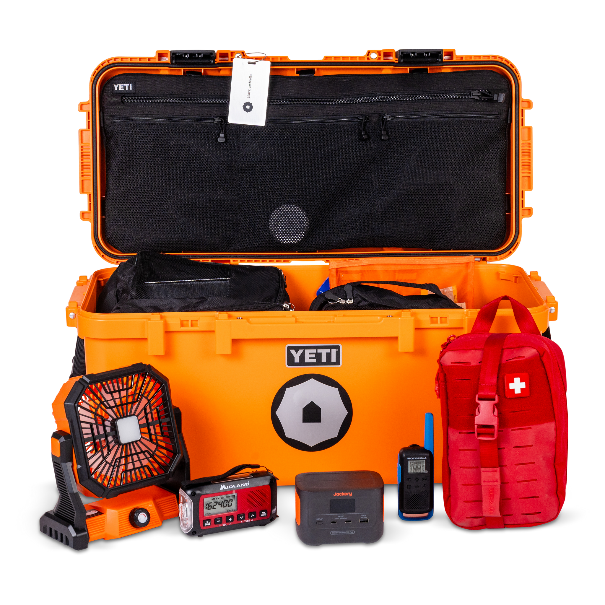 Orange YETI cooler with various items including a red first aid kit and black fan on a white background